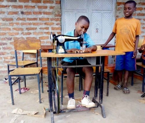 pupil using a treadle sewing machine