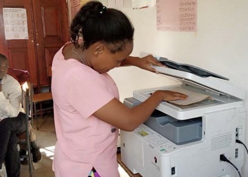 Using the new photocopier at uphill junior school in uganda