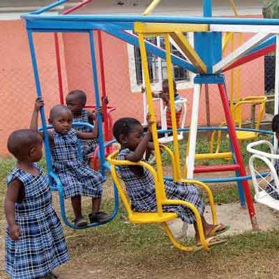 Children enjoying new Playground Equipment at Uphill Junior School in Uganda