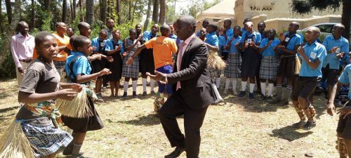 uphill director dancing with some of the pupils