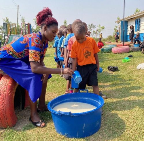 children lining up for daily porridge