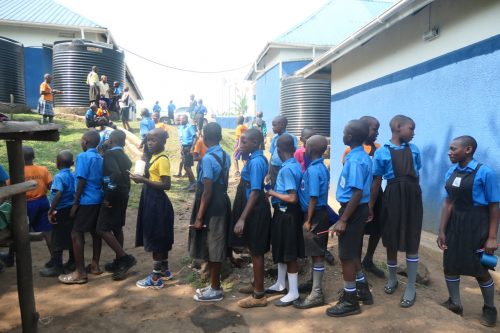 children lining up for daily porridge