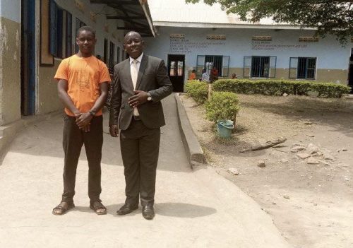 Uphill school director with one of his former pupils who is now at secondary school