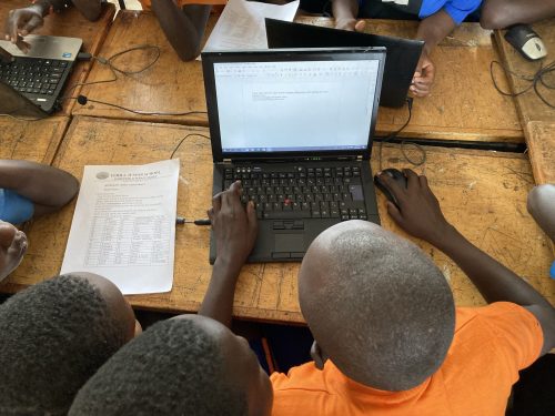 IT skills lesson at uphill junior school in rural uganda