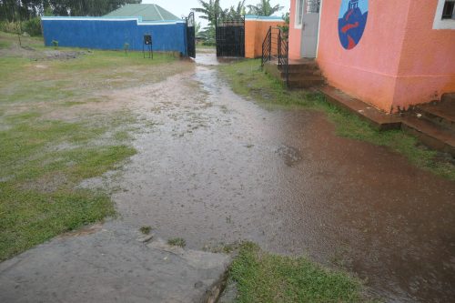 large puddles form at the front of uphill junior school during heavy rain